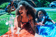 © Inti St. Clair - Cheerful girls playing on slip 'n slide in backyard