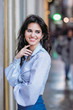 © lymdigital - young sexy girl enjoys smiling taking a walk in the city, joy concept
