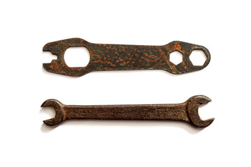 Old, rusty spanners on a white background