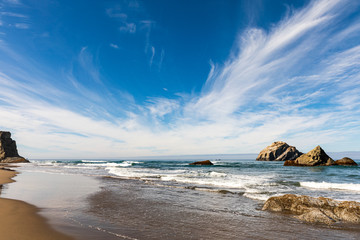 Wall Mural - Blue sky above sea stacks along Bandon beach in Oregon
