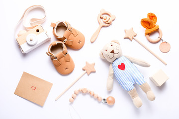 Set of baby shoes, toys and accessories on white background. Newborn stuff. Flat lay, top view