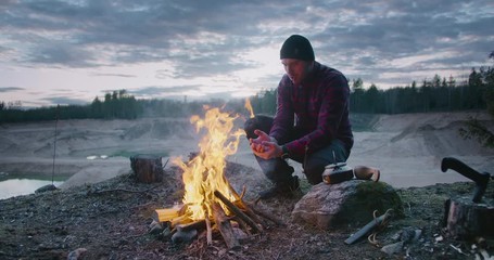 Wall Mural - man hiker make fire in forest.make the fire in nature. camping