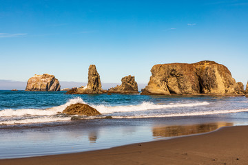 Wall Mural - Waves breaking on sea stacks along Bandon Beach in Oregon