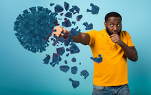 Man Attacks With A Punch The Coronavirus. Blue Background