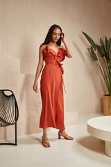 Wall Mural - Fashion model brunette hair wear red silk dress sandals high heels accessory clothes for date party walk interior furniture journey summer collection plant flowerpot wall stairs beautiful woman.