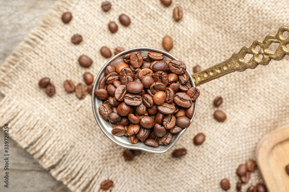 Pot with coffee beans on table
