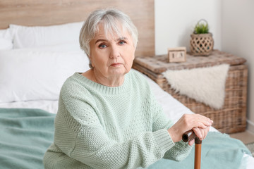 Wall Mural - Elderly woman suffering from mental disability at home