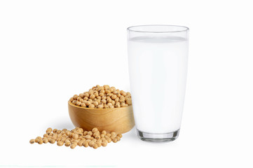 Glass of soy milk and soybeans in wooden bowl isolated on white background.