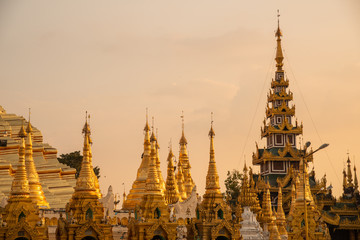 Group of stupa in area of Shwedagon pagoda is Yangon's most famous landmark in Myanmar at sunset. Shwedagon Pagoda enshrines strands of Buddha's hair and other holy relics.