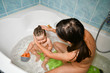 © SYARGEENKA - Mom washes the babys head. Joint bathing baby and mom. A symbol of cleanliness and hygiene education.