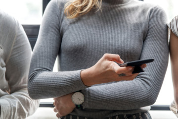 Canvas Print - Woman typing on a smartphone