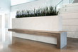 A modern beautiful custom planter bench made with stonelike and woodlike porcelain