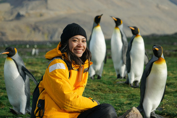 woman with penguins in background