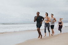 Fit People Jogging On The Beach