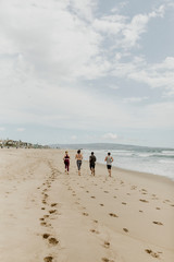 Canvas Print - Fit people jogging on the beach