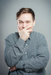 © aeroking - portrait of young man with hand on mouth