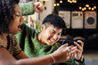 © rawpixel.com - Couple playing online mobile game