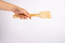 Hand Holding A Wooden Spatulas For Cooking.on White Background.