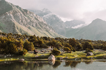 Tajikistan. Fann mountains. Summer. Beautiful mountain landscape. the mountains are covered with snow. Green-blue water (lake)