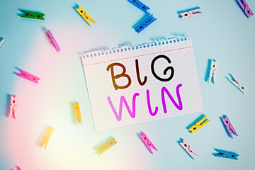 Writing note showing Big Win. Business concept for having won an important prize Money won by success in a game Colored clothespin rectangle shaped paper blue background