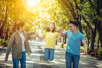 Wall Mural - Young asian family with child having fun in nature park