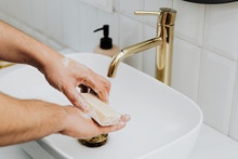 Man Using A Bar Soap To Wash His Hands