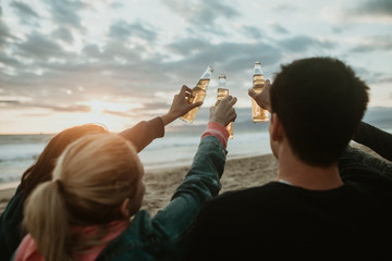 Wall Mural - Friends drinking by the beach