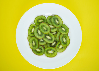 Wall Mural - Close up of a plate of green kiwi fruit slices
