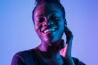 © F8  \ Suport Ukraine - Young elegant african american woman in fashionable neon light background.