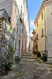 Fototapeta Panele - A narrow street between the old houses of a medieval village