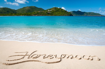 Wall Mural - romantic island honeymoon message written in smooth sand on bright tropical beach
