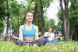 © adam121 - Girl meditates in lotus pose on green grass