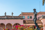 Fototapeta  - View of naked bronze statue of David in the garden of big american mansion