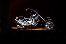 Motorcycle On A Black Background Under Lighting
