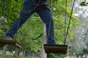 man on the ropes course, stepping