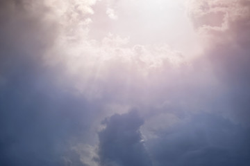 Wall Mural - rays of sunlight break through the dense cloudy sky