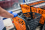 Fototapeta  - washing the shopping trolley - disinfection. Coronavirus pandemic - COVID-19