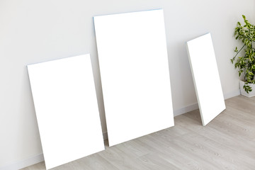 Mockup photo canvas in interior. Empty canvas for design. White brick wall on background.