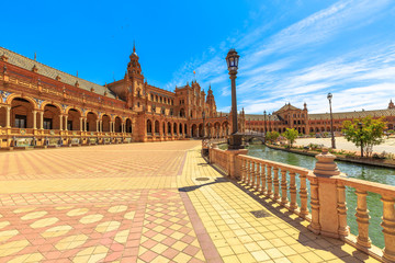 Renaissance central building with columns and arches in the semi-circular Plaza de Espana in Seville. Spain Square a popular landmark in Andalusia, Spain with channel of Guadalquivir.