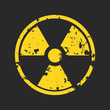 Vector illustration of grunge yellow radioactive hazard warning sign painted over black background.