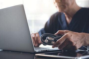 Wall Mural - Doctor working on laptop computer