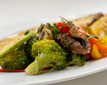Sole Meunière Fish With Grilled Vegetables And Caramelized Onions On A White Plate With White Background. LENGUADO MENIER