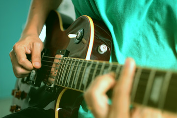 Wall Mural - Man playing on electric guitar, a pleasant, relaxing day, music and sound concept, Closeup