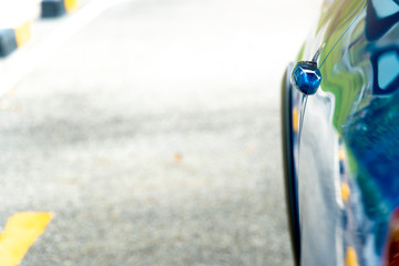 Wall Mural - Close door handle of blue car on the asphalt road. Prepare for race.