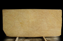 A Large Slab Of Natural Yellow Stone With Red Small Veins Is Called Crema Valencia Marble