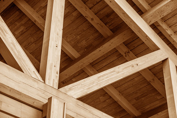 The construction of the wooden roof. Detailed photo of a wooden roof overlap construction.