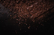 © Tanya - Cocoa beans, cocoa powder, cocoa butter, chocolate bar and chocolate sauce, chocolate bar in a wooden bowl on a dark background place for text