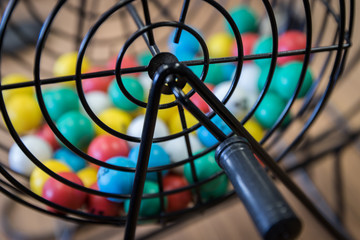 Wall Mural - A close up of a bingo cage filled with multi-colored balls. Each ball has a letter and number on it that corresponds to a number on the player's bingo card. Bingo is a game of chance.