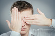© aeroking - young man closes his eyes with his hands