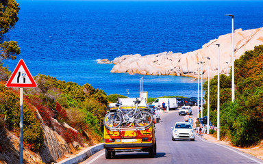 Canvas Print - Camper car with bicycles driving in highway road Capo Testa reflex